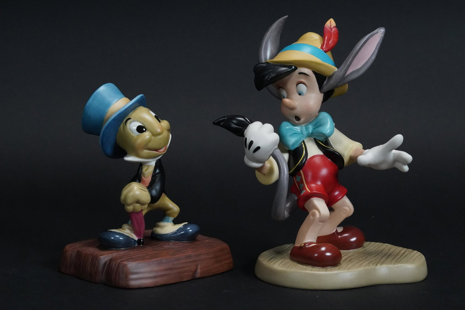 2 pcs Pinocchio figurines: 2 pcs WDC Pinnochio fine figurines, one was numbered 956 of 1,500. One was signed by original artist. Both comes with COA and original box. Largest H: 5" x W: 4.4."
