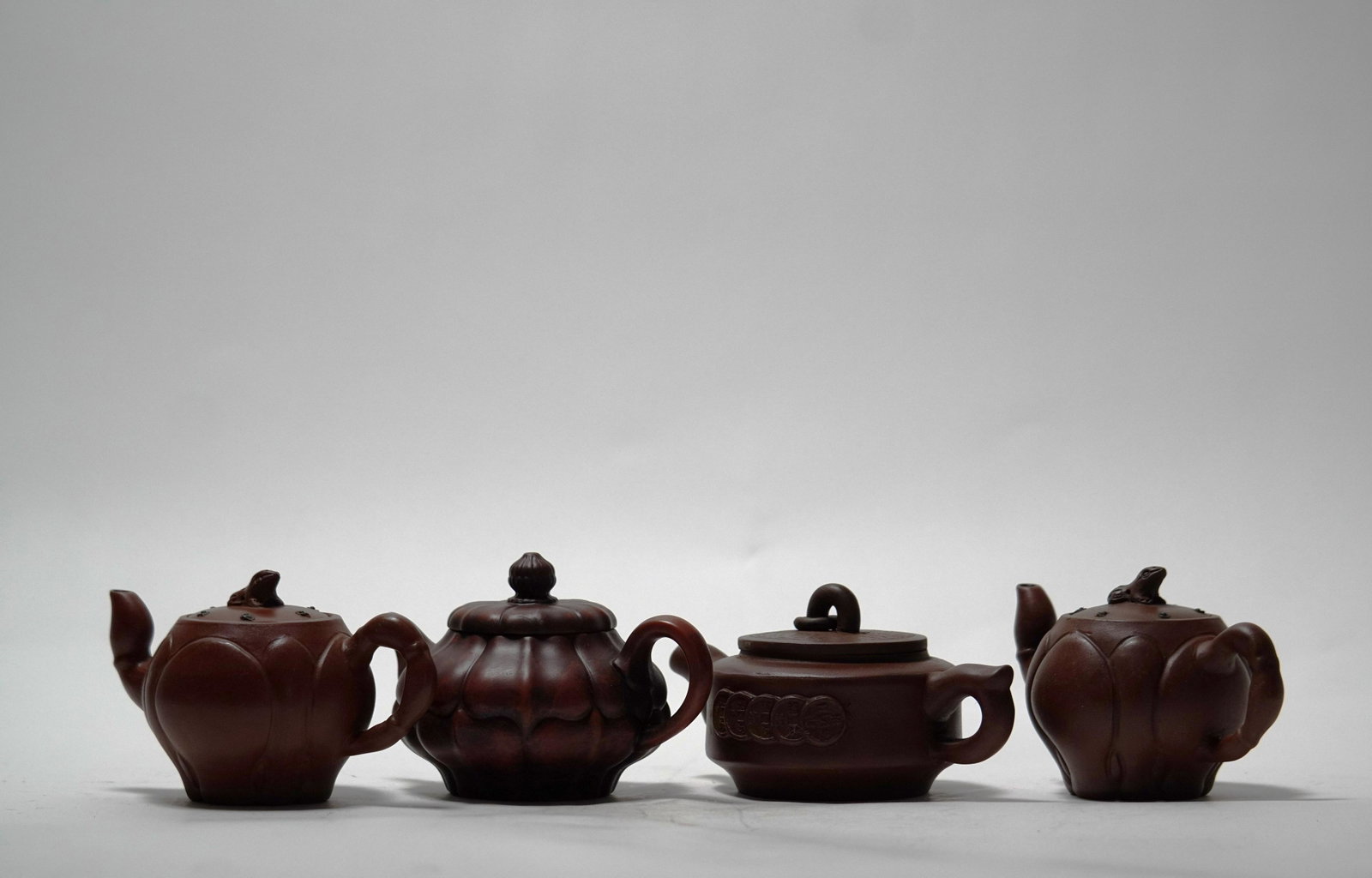 4 pcs Chinese clay teapot: 4 pcs Chinese fine clay teapot. Largest H: 3" x W: 7."