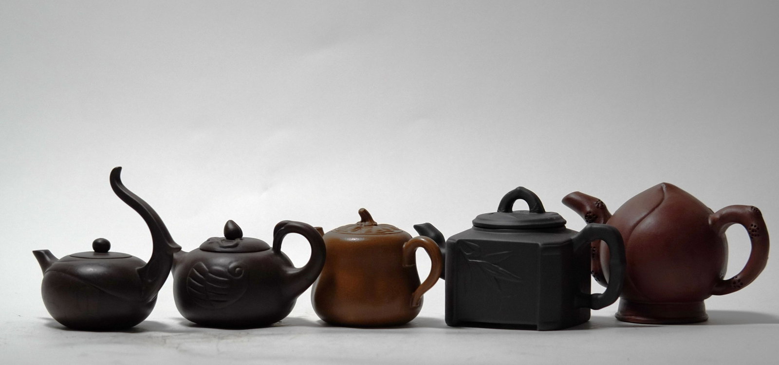 5 pcs Chinese fine clay teapots.: 5 pcs Chinese fine clay teapots. Largest H: 4" x W: 7."