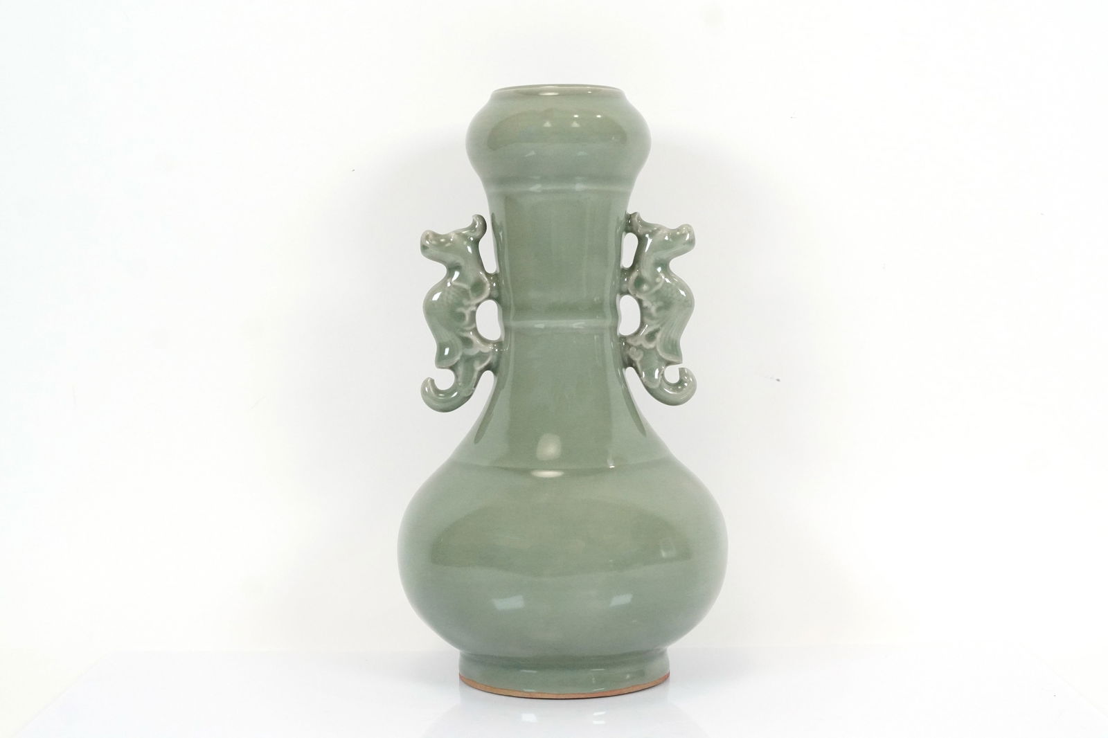 Chinese heavy celadon vase: Chinese heavy celadon glaze vase. H: 9.25" x W: 5.2."
