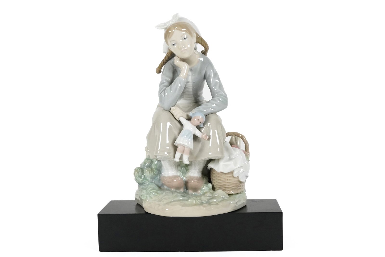 Lladro girl with doll: Lladro girl with doll figurine. H: 9.5" x W: 5.5."