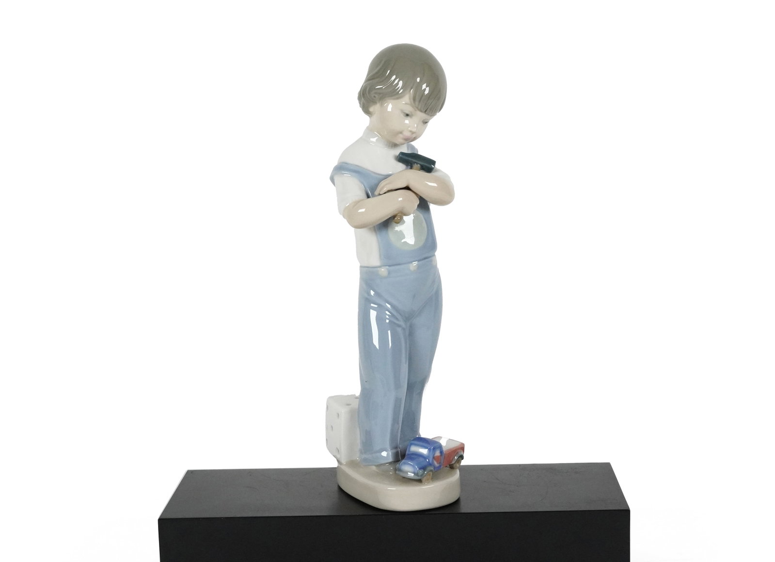 Lladro boy with hammer: Lladro boy with hammer figurine. H: 8.75" x W: 2.75."