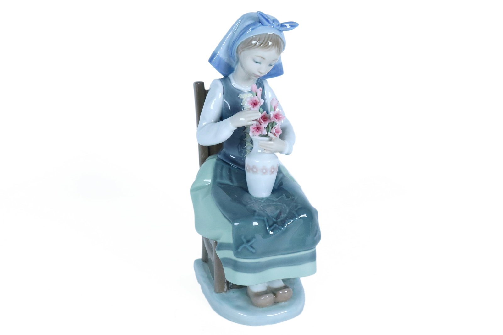 Lladro girl with flower: Lladro girl with flower. H: 8.25" x W: 2.75."