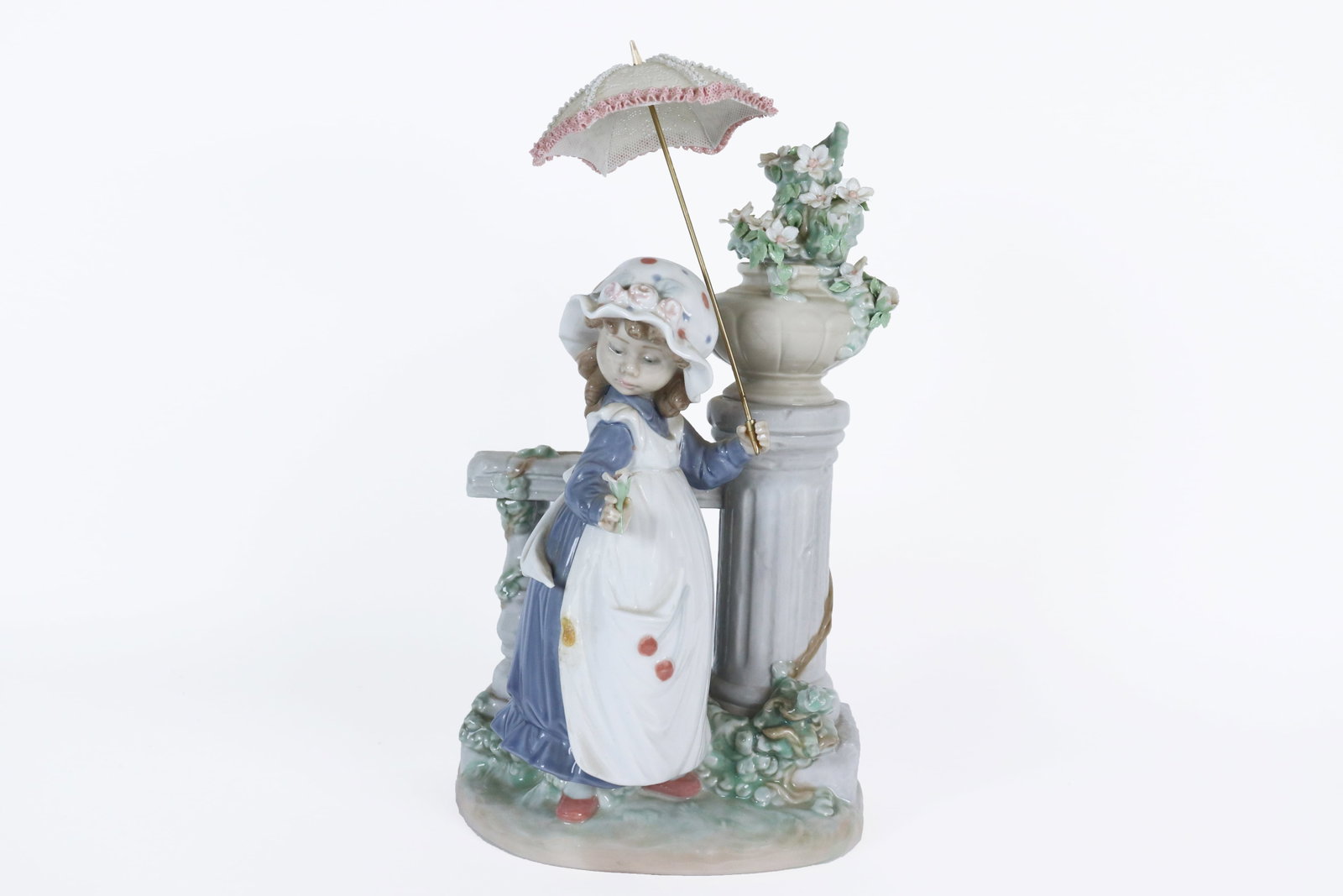 Lladro large flower girl: Lladro large umbrella girl with flower. H: 12" x W: 6."