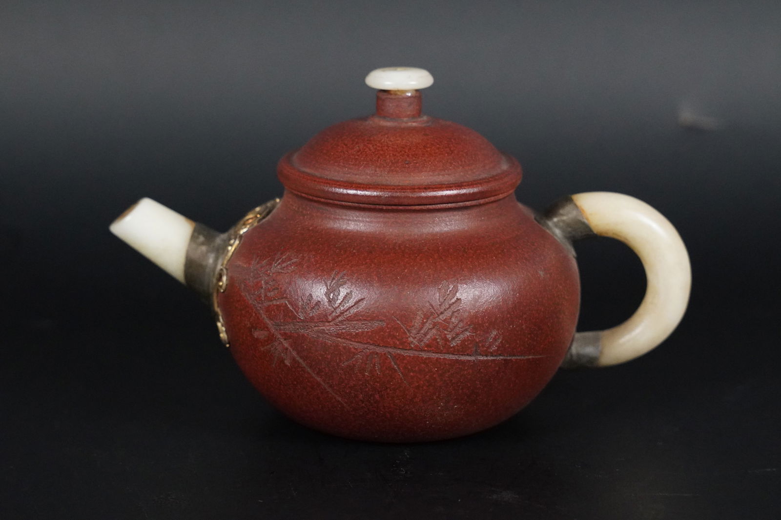Chinese clay teapot: Chinese fine clay teapot, with jade spout. H: 4" x W: 6.5."