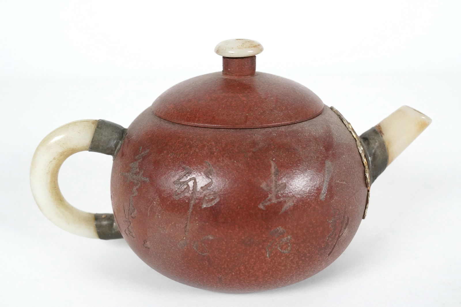Chinese fine jade teapot: Chinese fine clay teapot, with jade spout. H: 3" x W: 6.2."