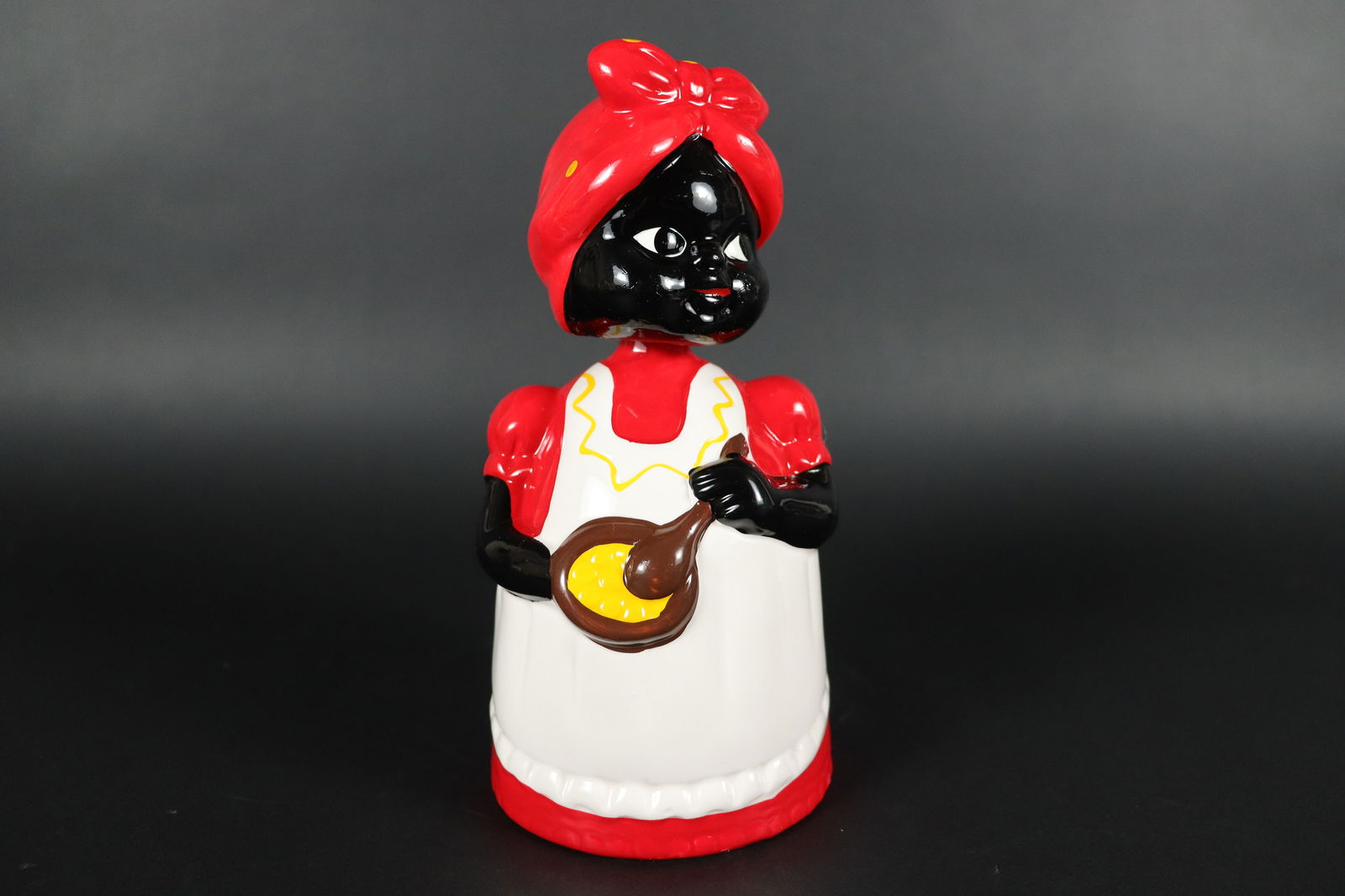 A vintage coin bank: A vintage coin bank. H: 8" x W: 4."