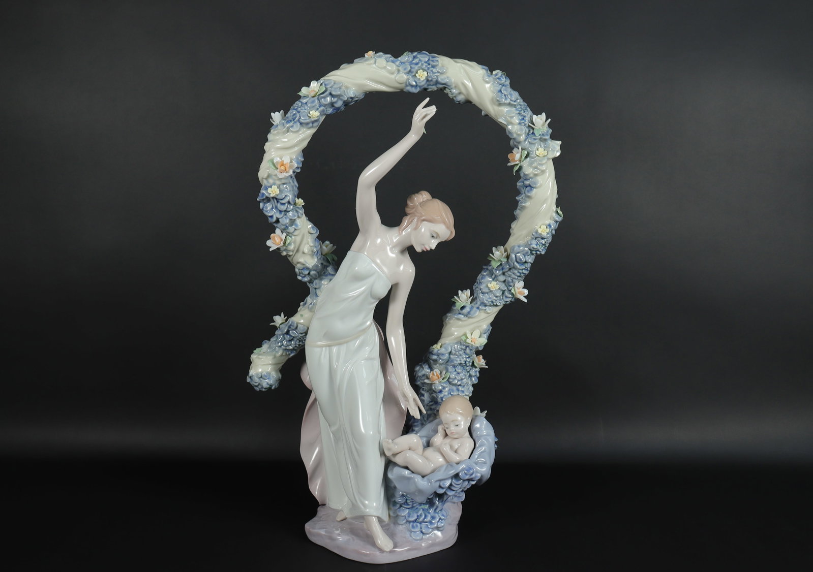 Lladro fine figurine: Lladro fine figurine, with some damage of flowers, please refer to detail photos. H: 16.25" x W: 10."