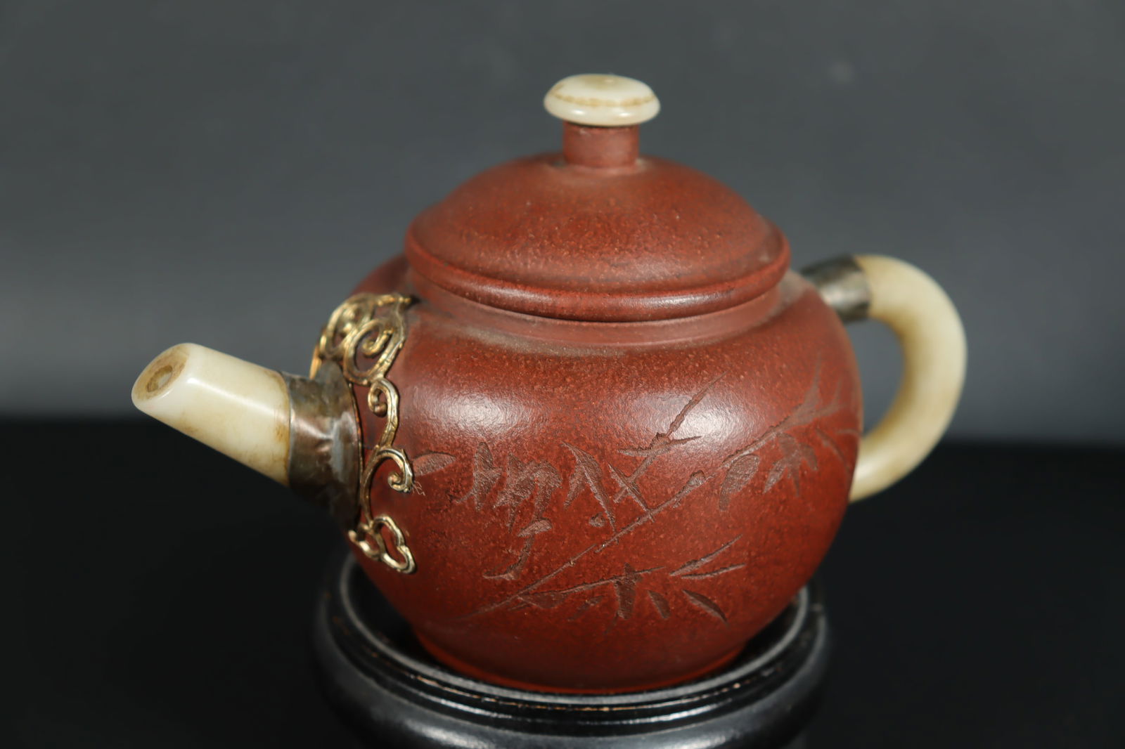 Chinese clay teapot: Chinese fine clay teapot, with jade spout. H: 4" x W: 6."