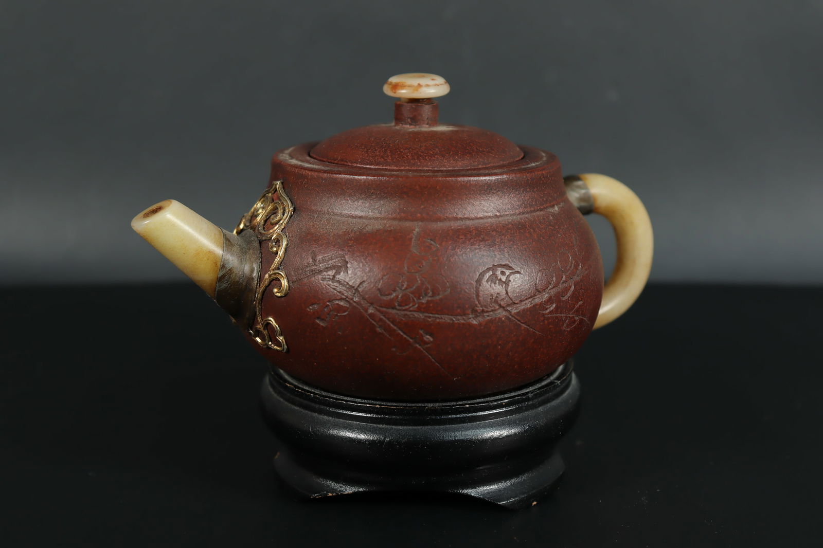 Chinese clay teapot: Chinese fine clay teapot, with jade spout. H: 4" x W: 6."