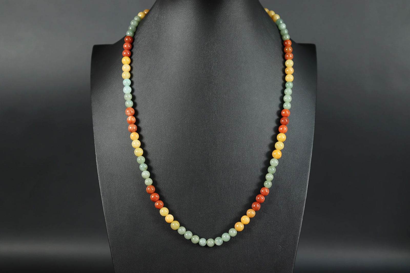 A jadeite beaded necklace: A long jadeite beaded necklace.