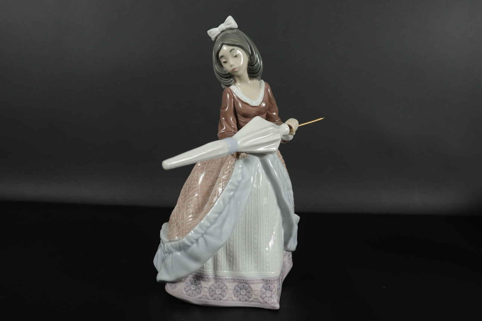 A Lladro girl figurine: A Lladro girl figurine.