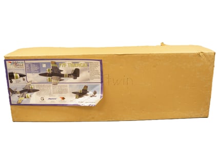 A large model RC airplane in box. H: 13.5" x W: 67."