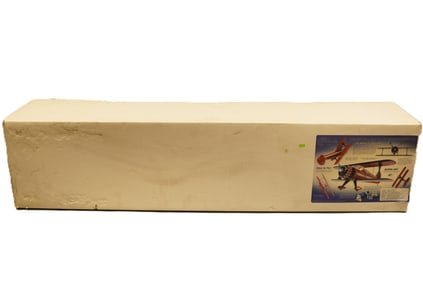 A large RC airplane in original box. H: 12" x W: 60."