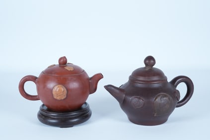 2 Chinese fine clay teapot. Largest H: 4.5" x W: 6.3."