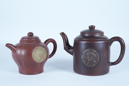 2 Chinese clay teapots. Largest H: 5" x W: 7.5."