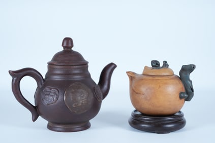 2 Chinese fine clay teapots. Largest H: 5.7" x W: 7."