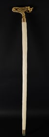 A long brass handled cane