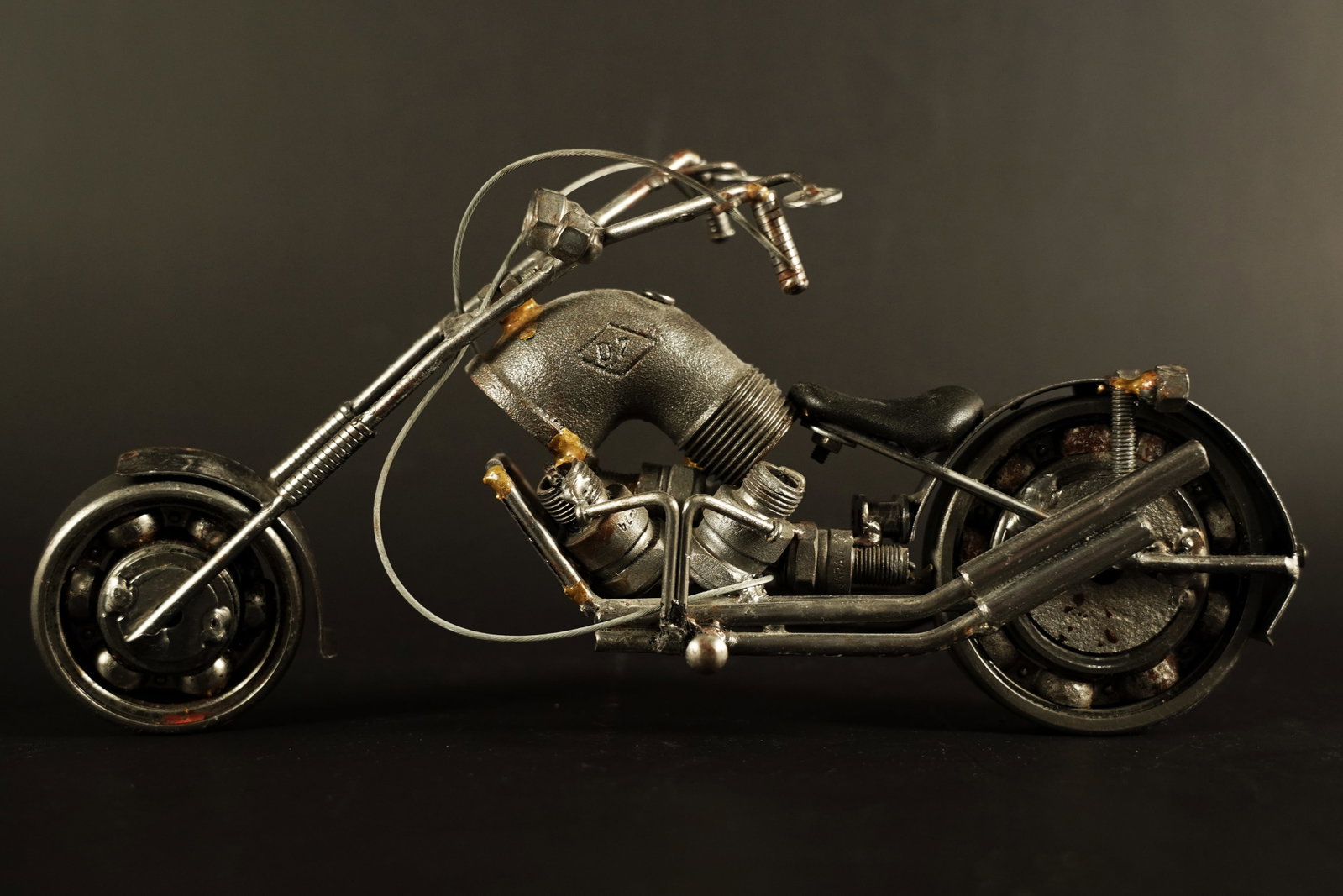 A metallic motorcycle: A metallic motorcycle. H: 6" x W: 11.5."