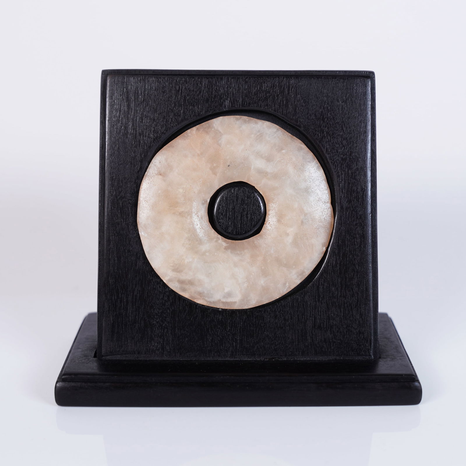 Chinese round stone insert: Chinese round jade insert into hard wood. H: 4.2" x W: 3.75."