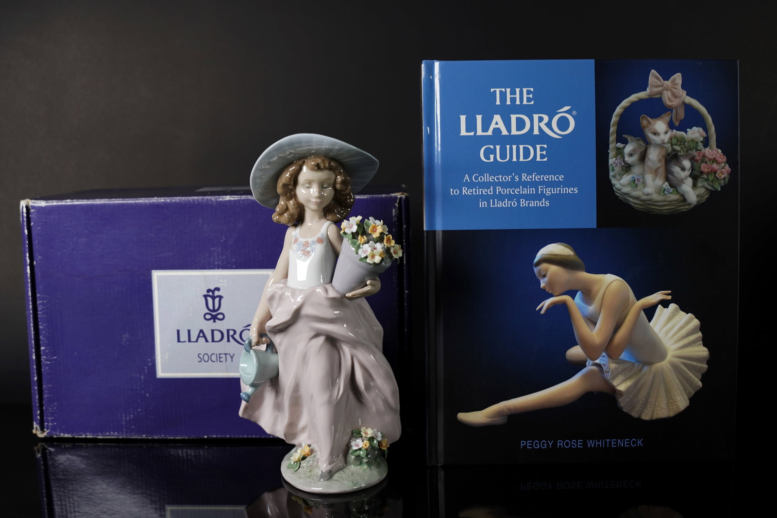 A Lladro girl figurine with box: A Lladro flower girl figurine with box. H: 9.5" x W: 5."