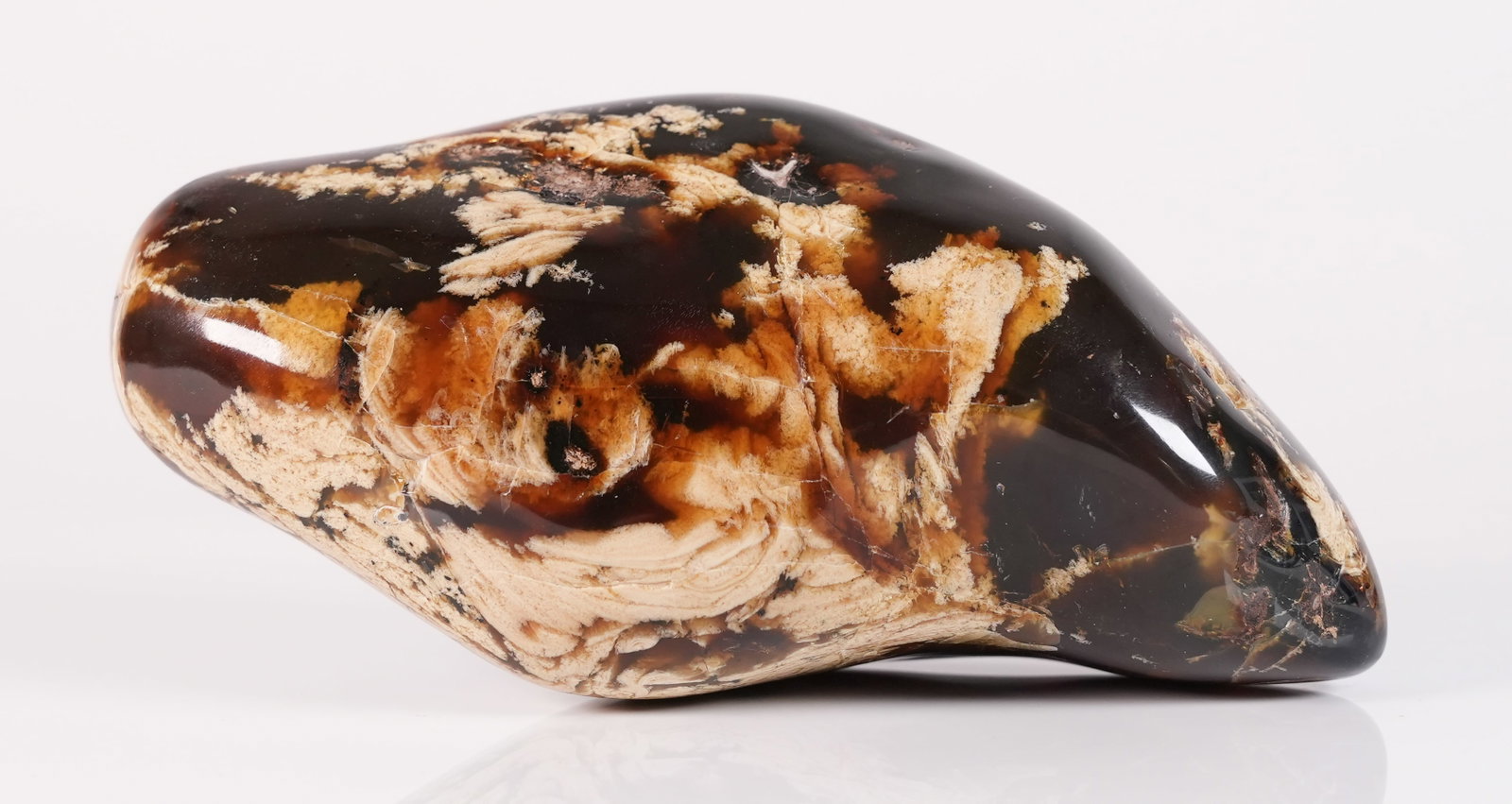 An amber boulder 665 grams: An amber boulder. H: 5.5" x W: 8.8." Total weight 665 grams.