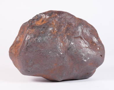 A possible meteorite boulder 18.5 lb: A possible meteorite boulder, heavy in weight. Total weight 18.5 lb. H: 6.5" x W: 10." Condition selling it as is, all sales are final.