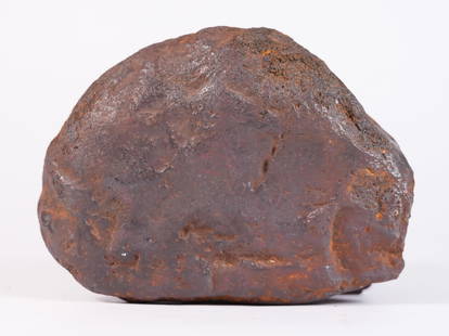 A possible meteorite boulder 7.25 lb: A possible meteorite boulder, heavy in weight. H: 2" x W: 7." Condition selling it as is, all sales are final.