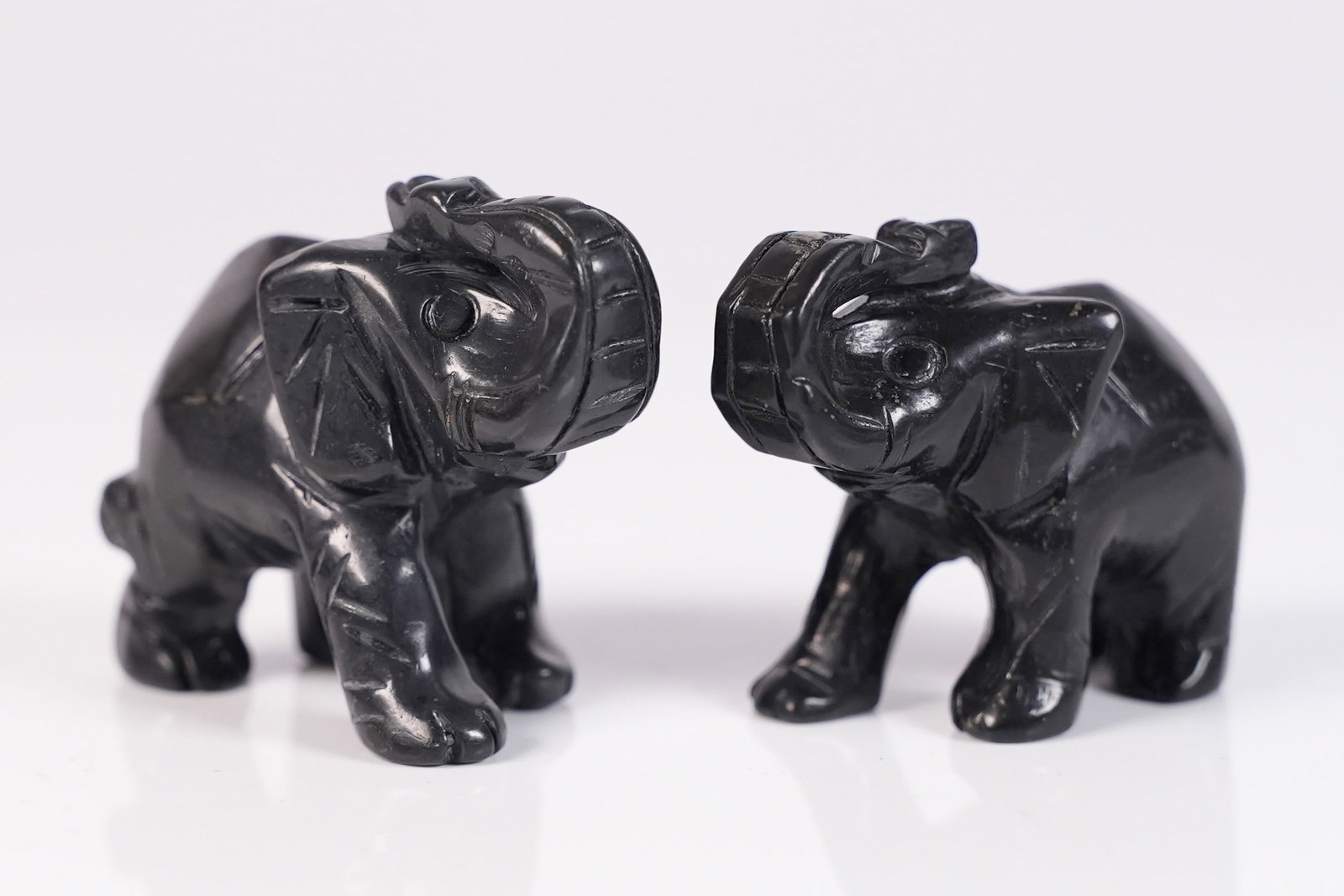 2 black tourmaline elephants: 2 black tourmaline carved elephants.