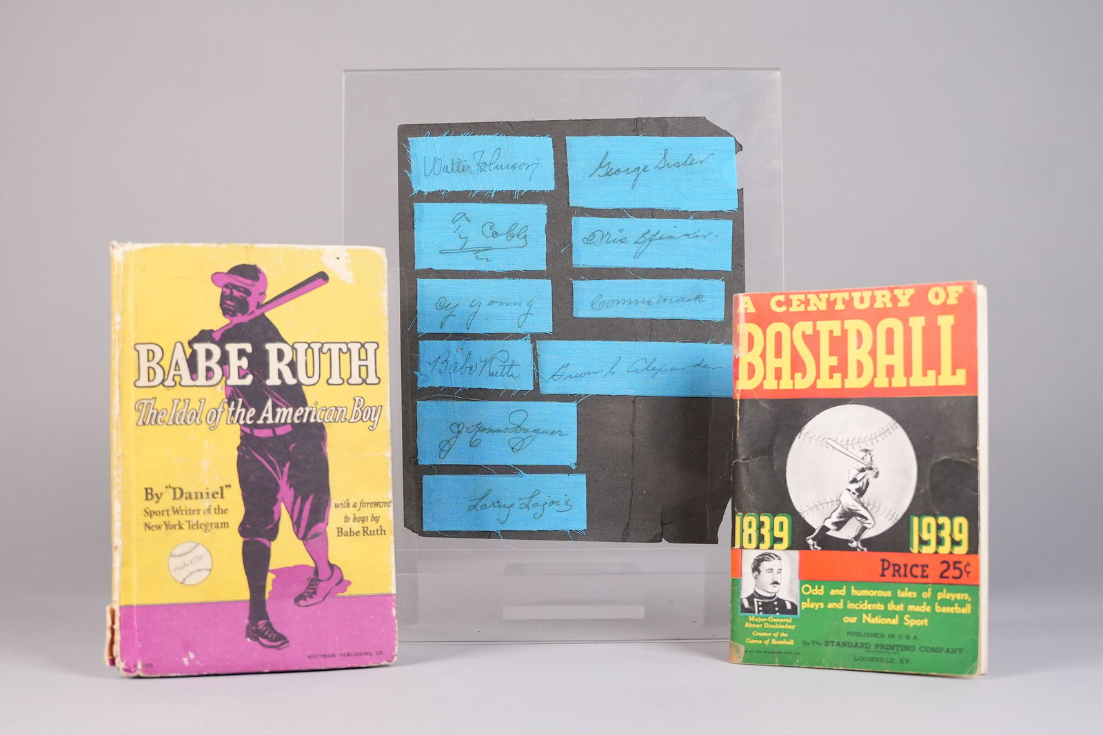 Babe Ruth signed book and baseball legends: Book signed by Babe Ruth and autographs from other legends. From an estate. Book signed and dated by the legendary Babe Ruth in 1931. Set of eight autographs signed on blue fabric cutouts, presumably