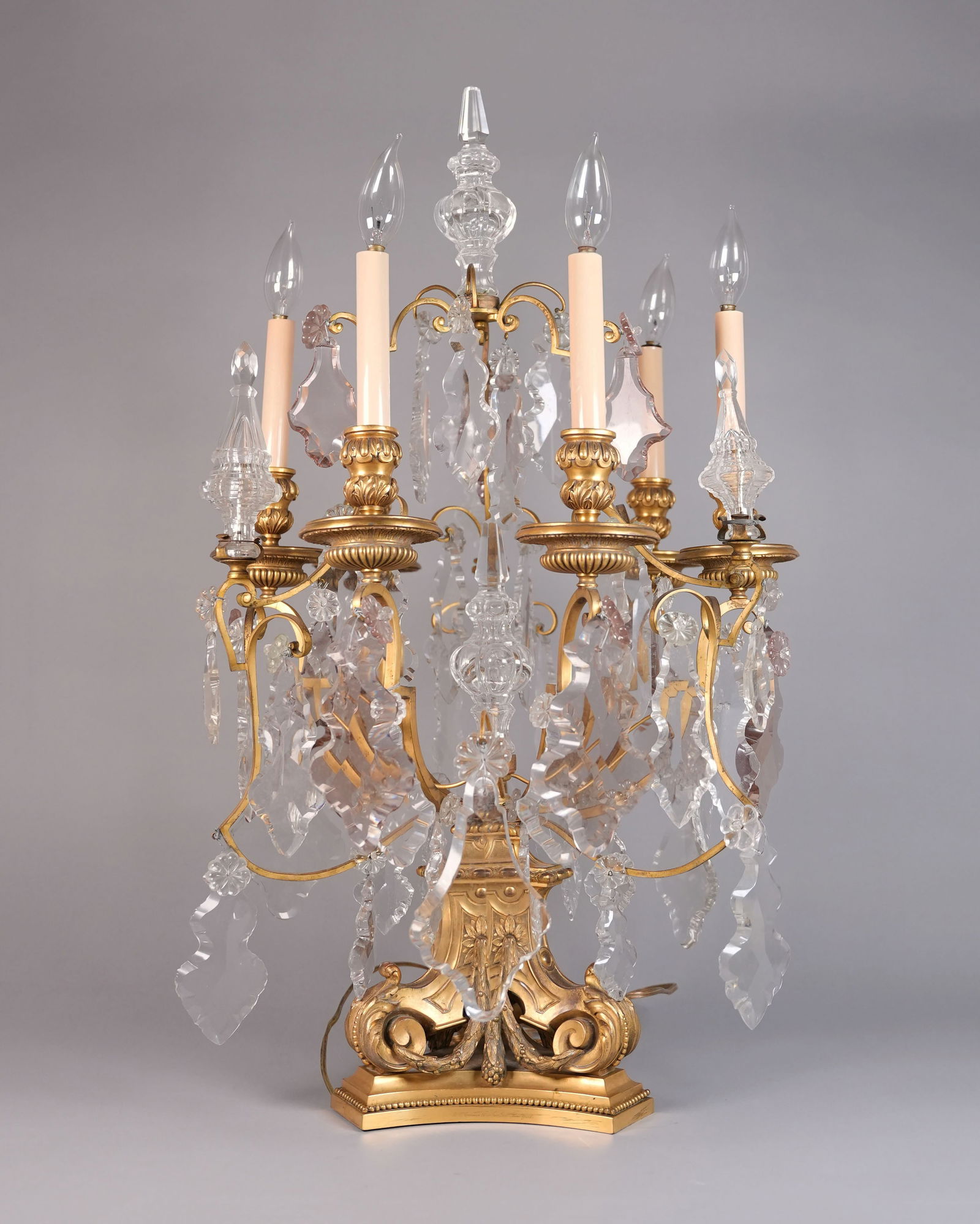 An antique crystal lamp: An antique crystal lamp, one of the crystal has some chipped. Condition selling it as is. H: 31" x W: 18."