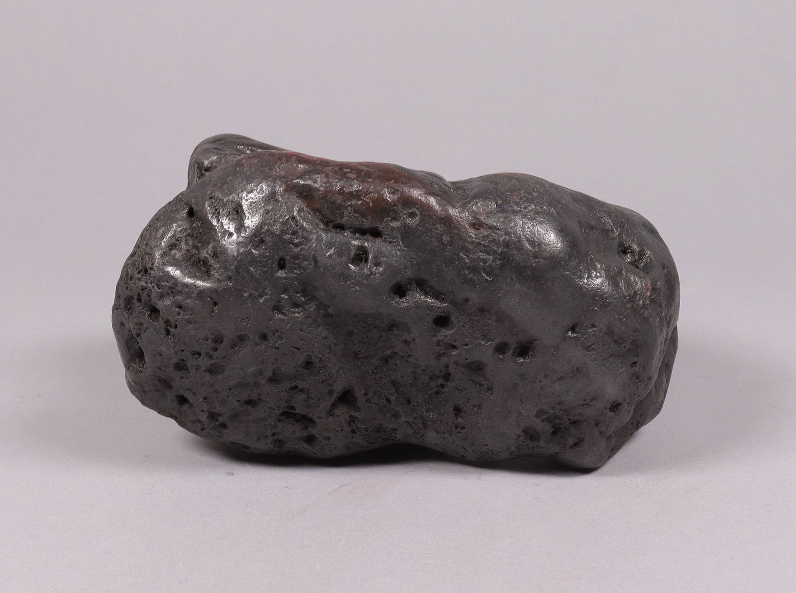 A possible meteorite boulder: A possible meteorite boulder, condition selling it as is. All sales are final. H: 3.5" x W: 7." Total weight 10.1 lb.