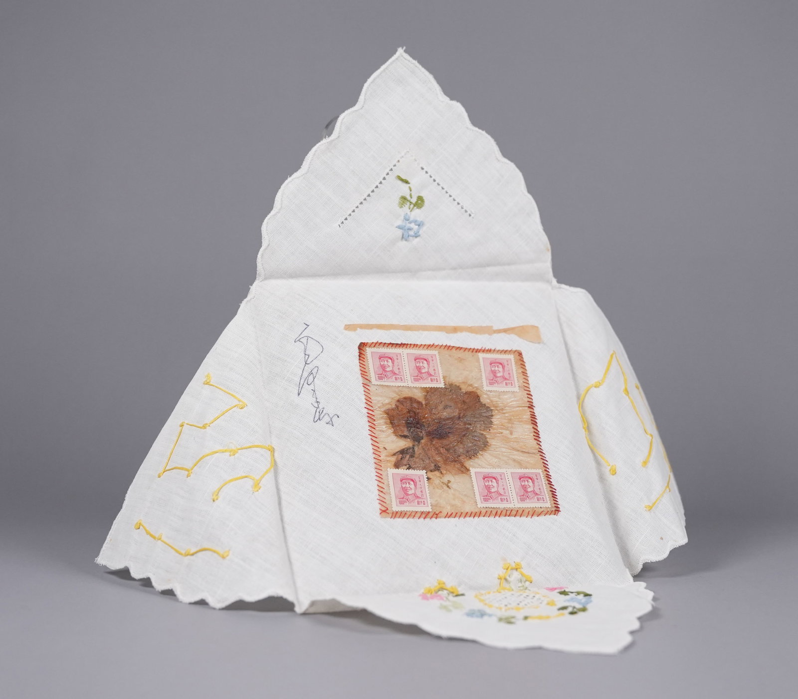 Chairman Mao signed napkin ungraded: Napkin allegedly signed at a banquet celebration by Mao Zedong, founder and communist leader of the People's Republic of China, president from 1949 until his death in 1976. It has a dried flower sewn 