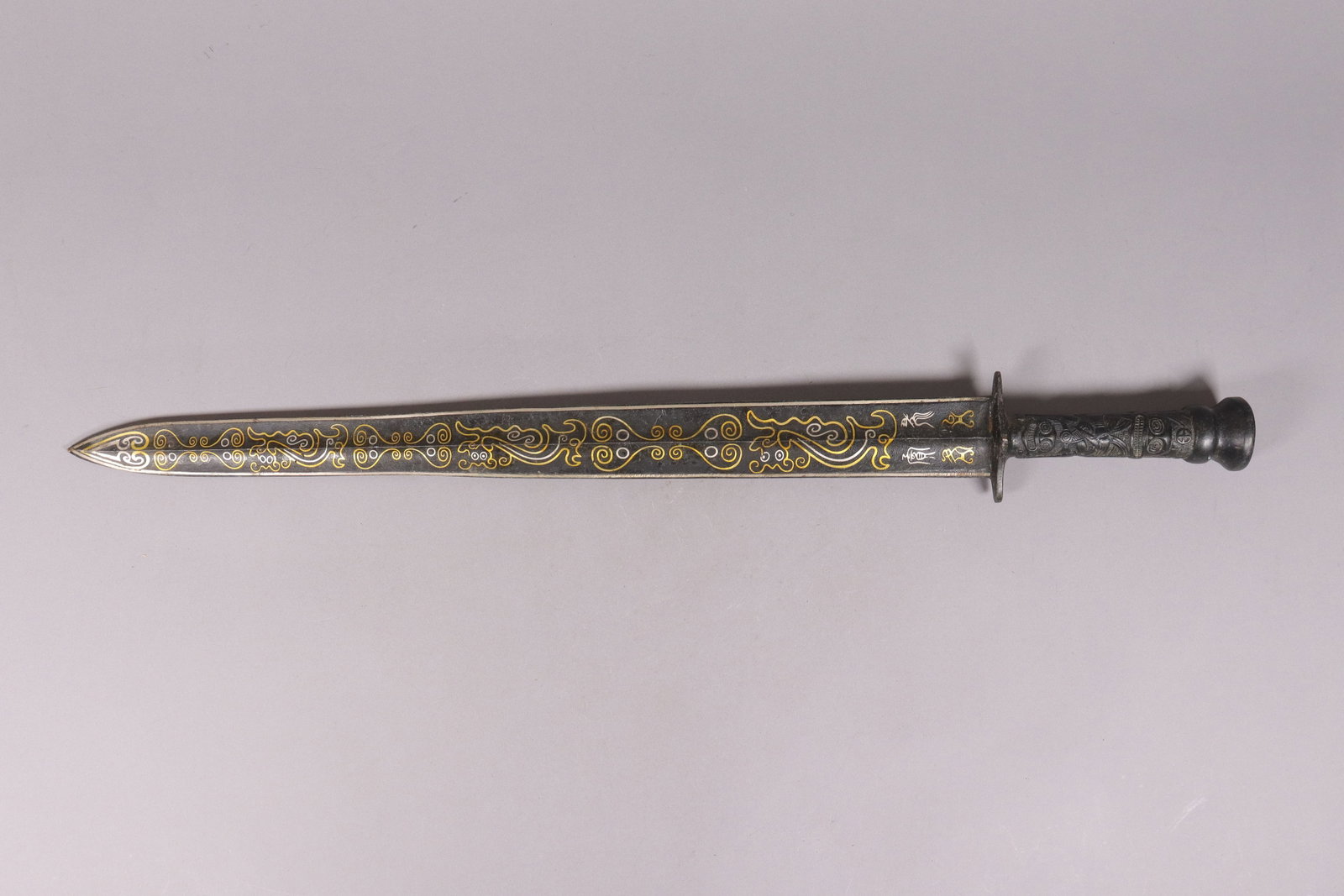 Chinese fine gilted inlaid bronze sword: Chinese fine gilted inlaid bronze sword. L: 0.4" x W: 25."