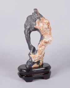 A carved boulder stone on stand