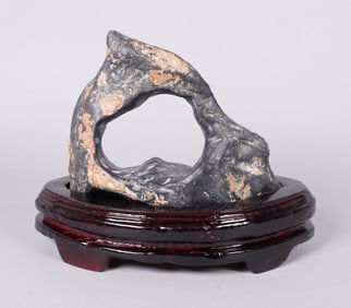 A carved boulder stone on stand