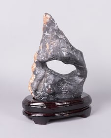 A carved boulder stone on stand