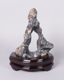 A carved boulder stone on stand