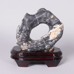 A carved boulder stone on stand