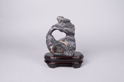 A carved boulder on stand