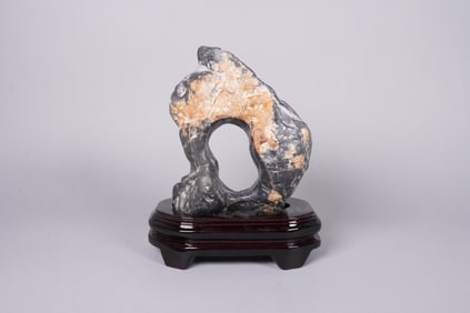 A carved boulder on stand