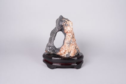 A rock boulder on wooden stand