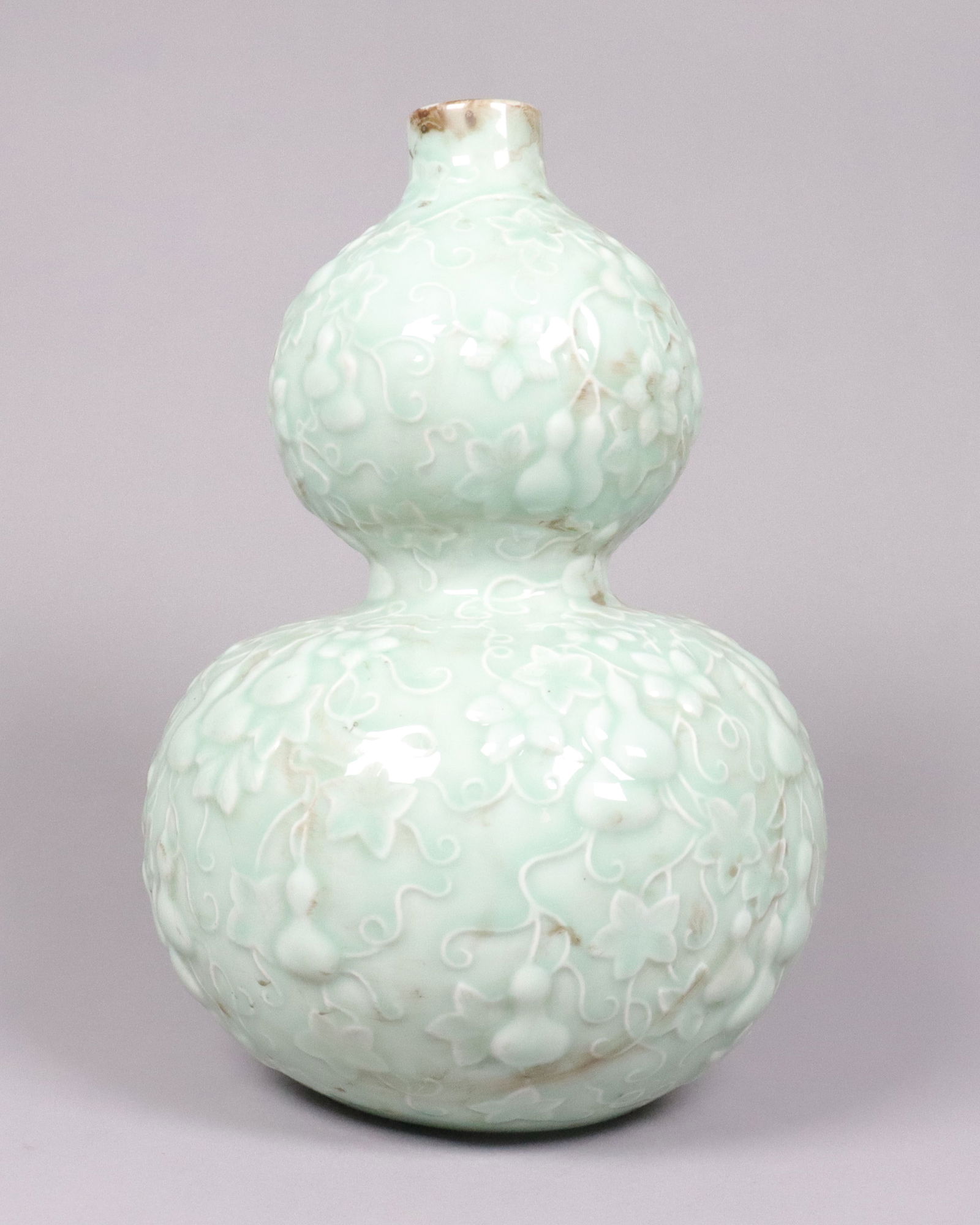 Chinese celadon gourd vase: Chinese fine celadon gourd vase, with maker's mark on the bottom. H: 12" x W: 7.5."