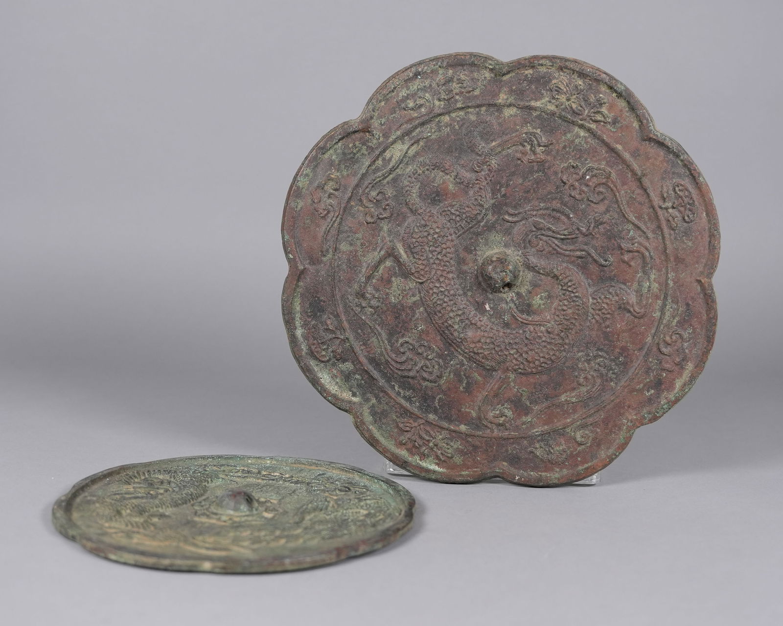 2 Chinese bronze mirrors: 2 Chinese bronze mirrors. Largest H: 1.3" x W: 10."