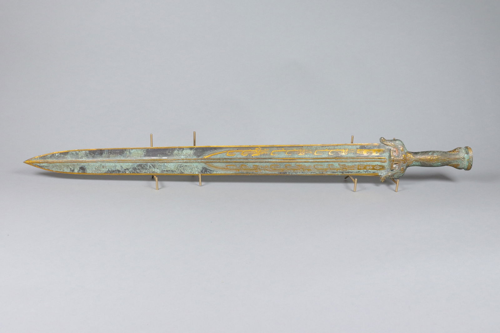 Chinese fine gilted bronze sword: Chinese fine gilted bronze sword. L: 35" x W: 4."