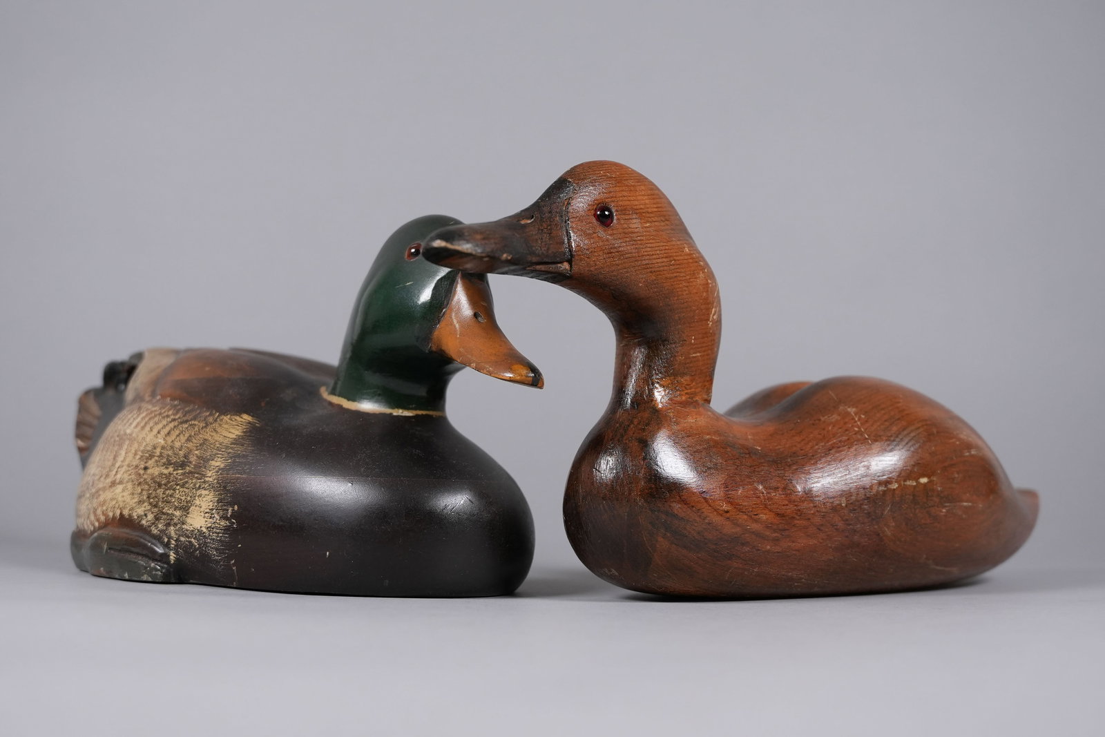 2 antique duck decoys: 2 antique duck decoys, one has some writing or carving underneath. Lagest H: 7" x W: 16.7."