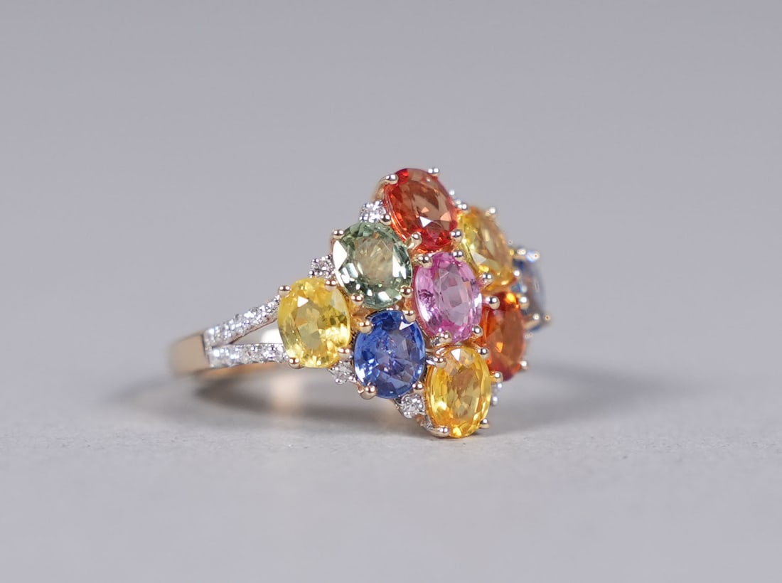 14 kt y/g sapphire ring: 14 kt colored sapphire ring. Total 3.90 carats sapphire. Total 0.17 carats diamond. US ring size 6.75.