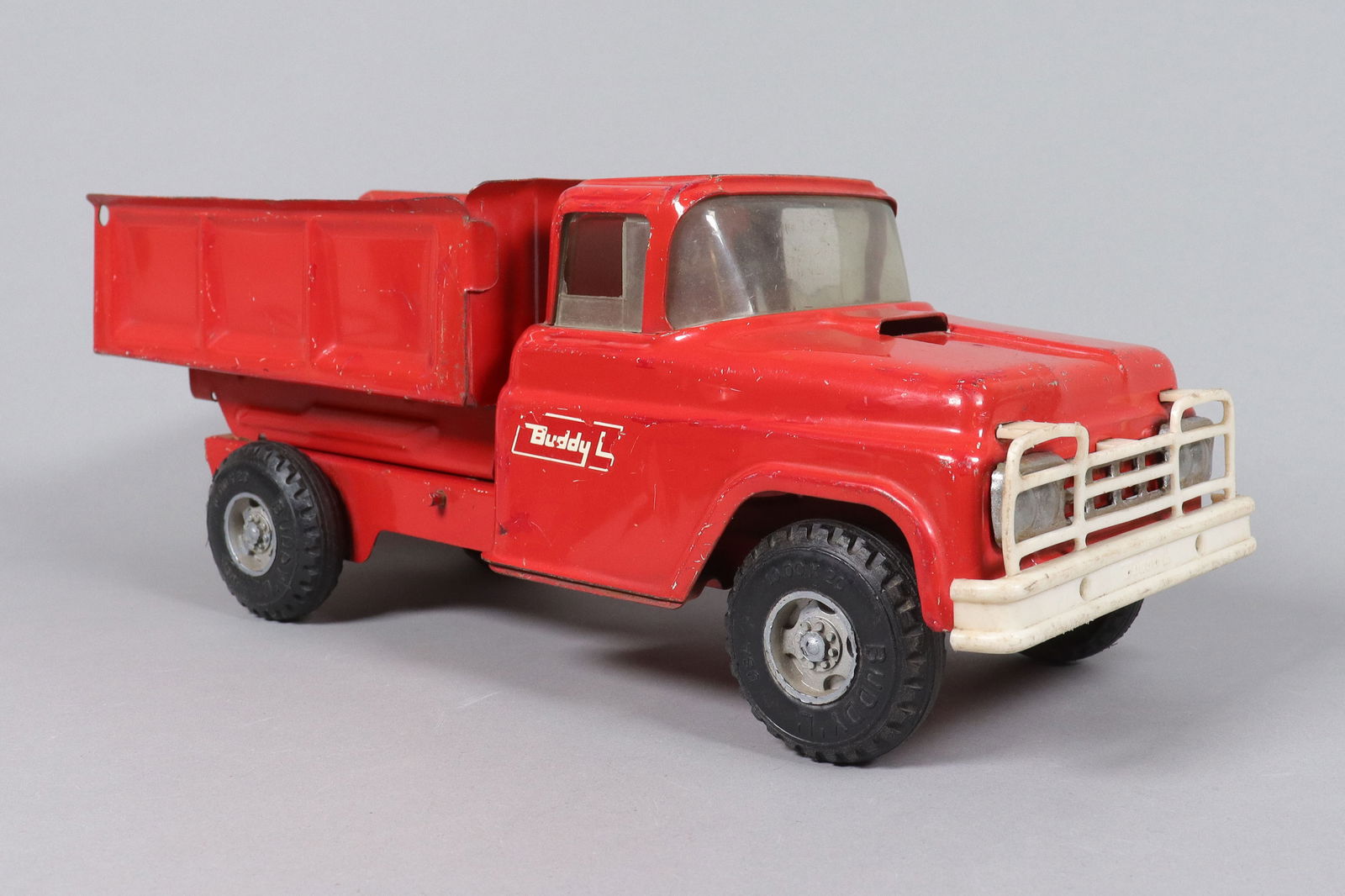 Buddy L dumpster truck: Buddy L red dumpster truck. H: 5.35" x W: 14.5."