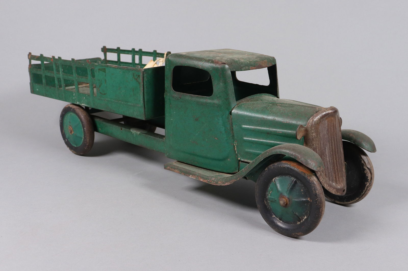 A vintage green truck toy: A vintage green truck toy. H: 6.75" x W: 20.25."
