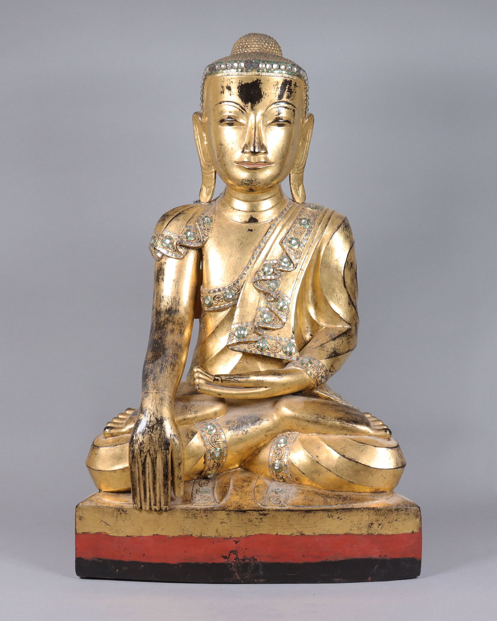 A gilted Burmese fine buddha statue: A gilted Burmese fine buddha statue, with jeweled. From an estate. H: 28" x W: 17.5."